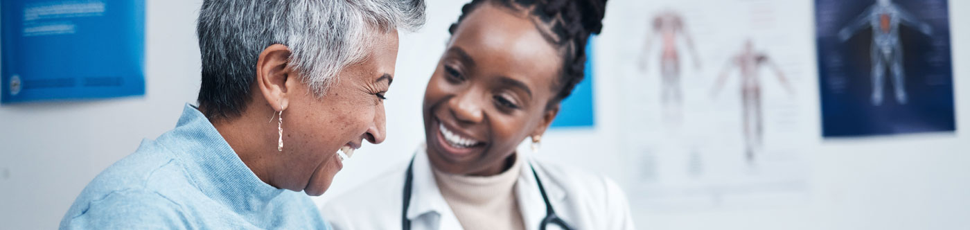 mature woman and young medical professional laughing together